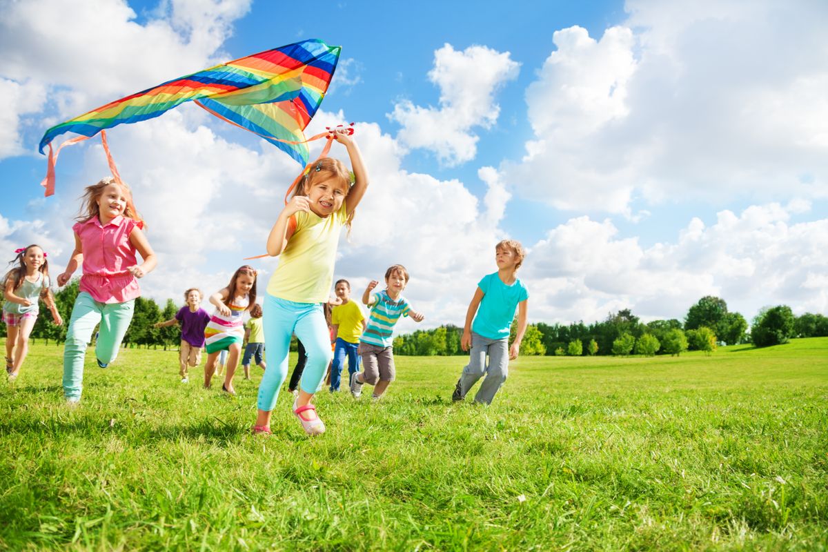 Cute,Little,Happy,Boys,And,Girls,Running,With,Kite,Together