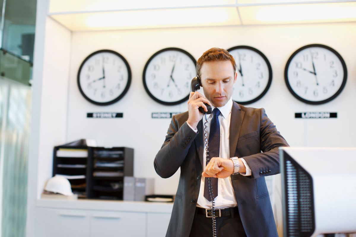 Businessman checking his watch in office NAV