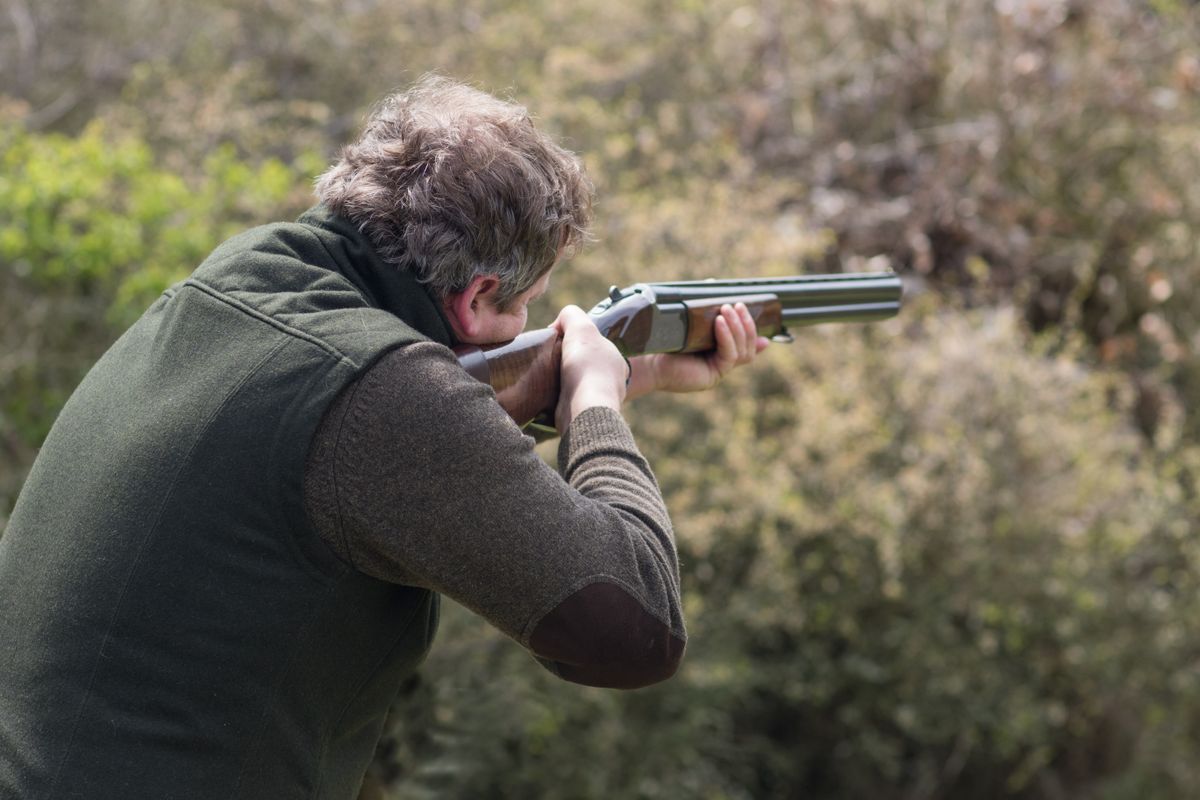 Hunter in forest during hunting season aiming before shoot vadász vaddisznó
